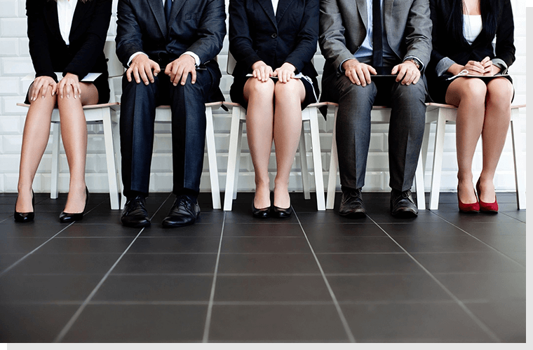 A group of people sitting on chairs in front of each other.